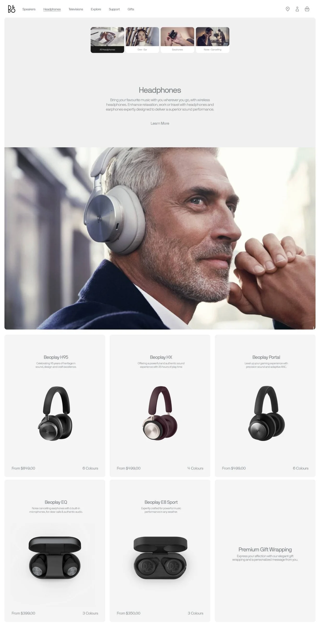 Headphones web page with a grey-haired man in silver headphones above a grid of Beoplay products, for Bang & Olufsen.