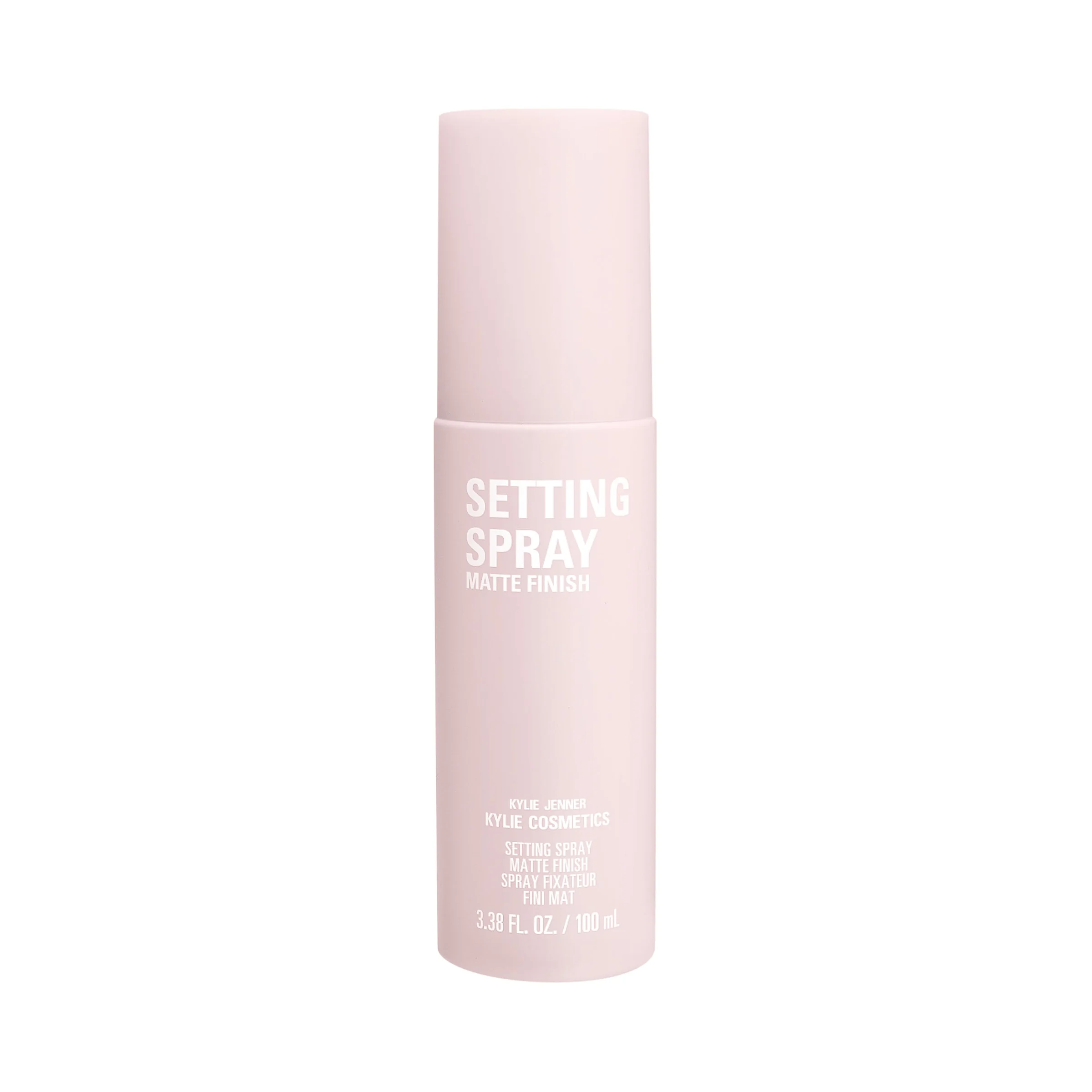 Pale pink matte finish setting spray bottle with white lettering on a white background, for Kylie Cosmetics.