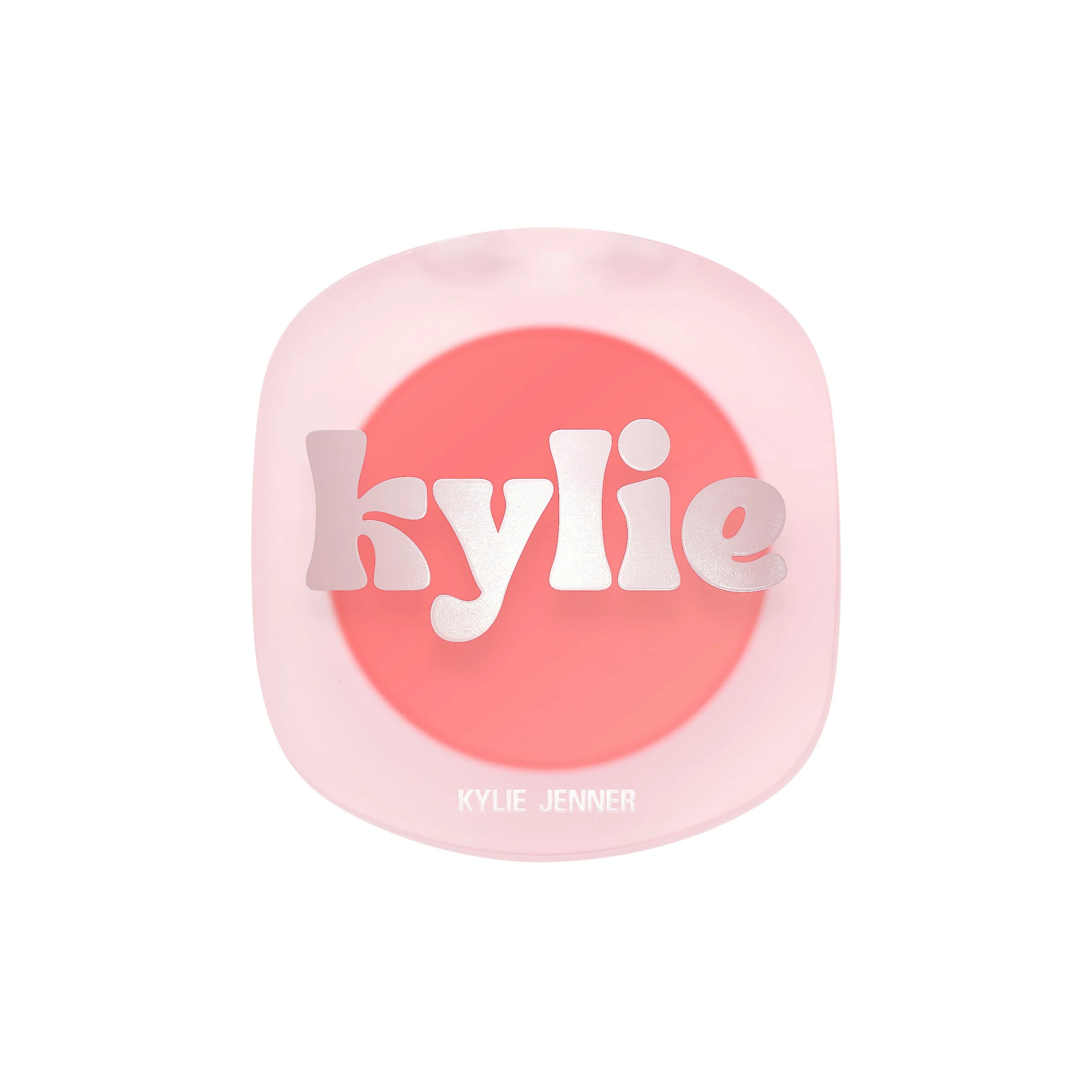 Frosted pink blush compact with a silver kylie logo over coral powder on a white background, for Kylie Cosmetics.
